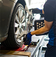 A mechanic performs an Alignment Check﻿ in this picture for coupons at DeLorenzo in Seminole