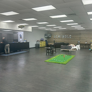 Photo of interior of auto repair office by DeLorenzo wth their logo on the far wall.