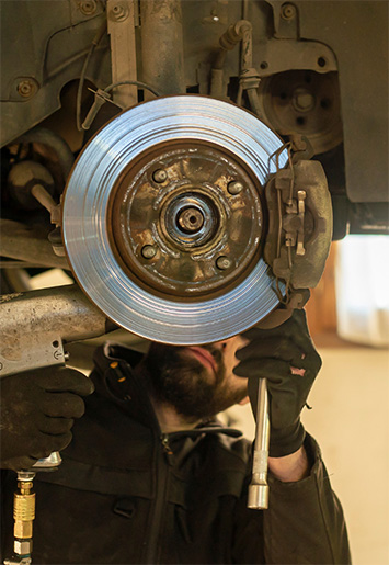Brakes getting checked during a car tune-up by DeLorenzo in Seminole. Come in for brake service today.