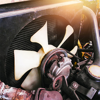 A white car fan exposed during cooling system services check-up in Seminole
