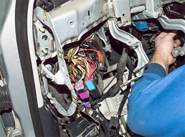 Mechanic performs electrical repair on a car in Seminole