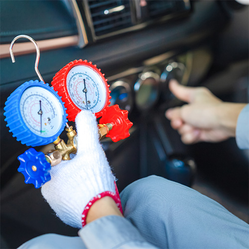 Gauges check output of air during an air conditioning repair by DeLorenzo Tire and Auto Services